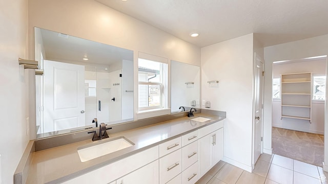 1396 S Castillo Rd W Unit 102, Spanish Fork, UT 84660 - bathroom featuring a spacious closet, double vanity, a sink, and a shower stall