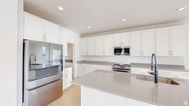 1396 S Castillo Rd W Unit 102, Spanish Fork, UT 84660 - kitchen featuring stainless steel appliances, a sink, light countertops, and white cabinets