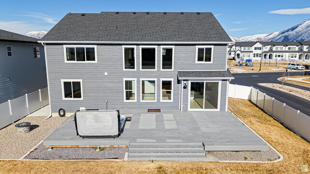 1396 S Castillo Rd W Unit 102, Spanish Fork, UT 84660 - back of house with a deck with mountain view, a fenced backyard, a residential view, and a shingled roof