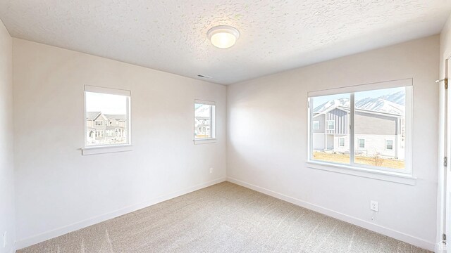 1396 S Castillo Rd W Unit 102, Spanish Fork, UT 84660 - empty room with carpet, visible vents, baseboards, and a textured ceiling