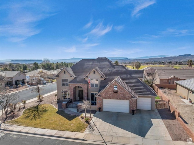 470 E 130 S, Ivins, UT 84738 - view of front of house with a garage, brick siding, and a mountain view