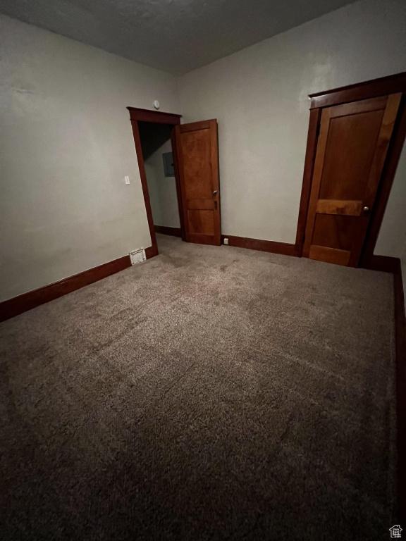 spare room with carpet and baseboards