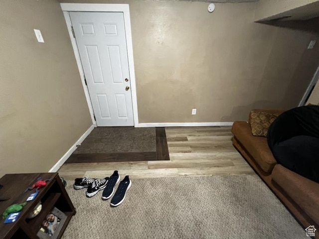 interior space featuring wood finished floors and baseboards