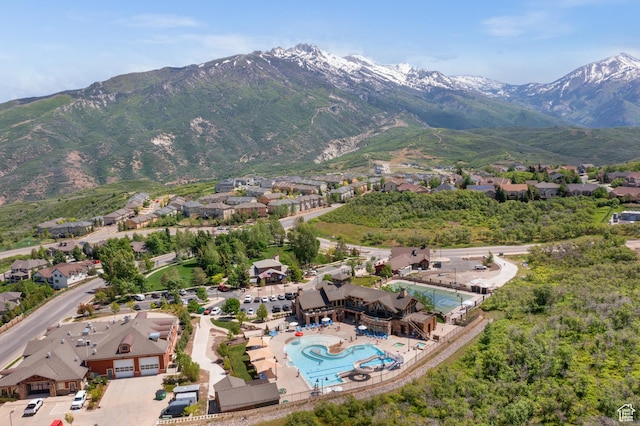 aerial perspective of suburban area with a mountainous background and a pool area