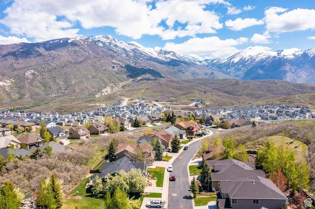 aerial view of property's location featuring nearby suburban area and a mountain backdrop