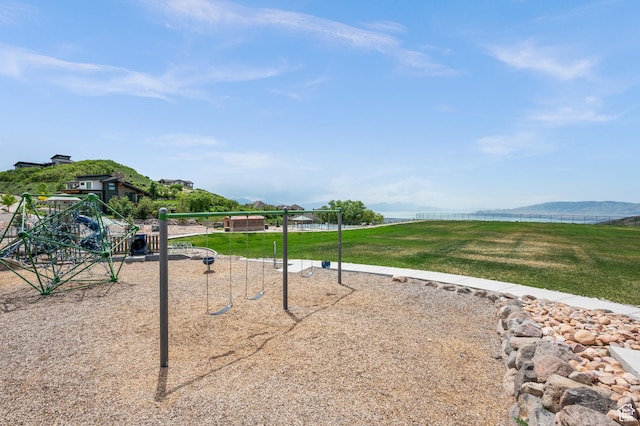 view of community featuring a lawn and a mountain view
