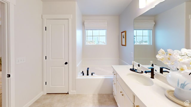 bathroom featuring a closet, a garden tub, and vanity