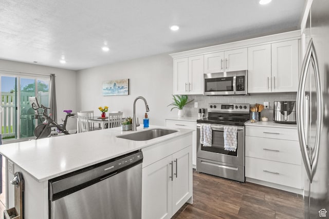 6471 S Aspen Ln, South Weber, UT 84405 - kitchen featuring stainless steel appliances, a sink, a kitchen island with sink, light countertops, and white cabinetry