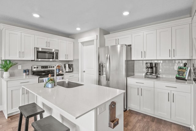 6471 S Aspen Ln, South Weber, UT 84405 - kitchen featuring stainless steel appliances, a sink, white cabinets, light countertops, and recessed lighting