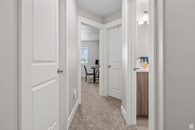 6471 S Aspen Ln, South Weber, UT 84405 - hallway with a desk, light carpet, and baseboards