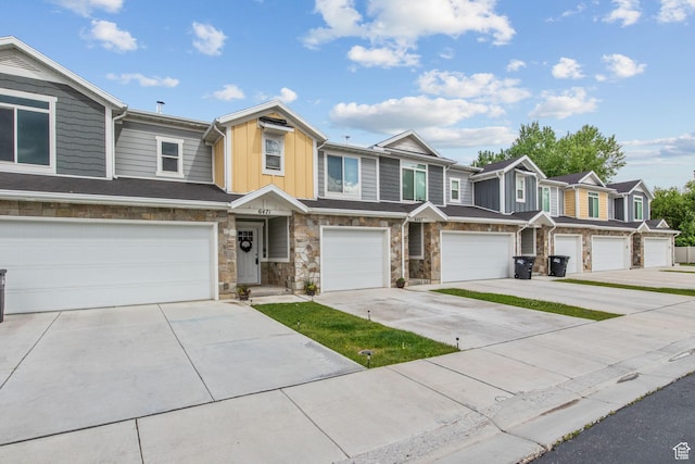 6471 S Aspen Ln, South Weber, UT 84405 - townhome / multi-family property with board and batten siding, driveway, a garage, stone siding, and a residential view
