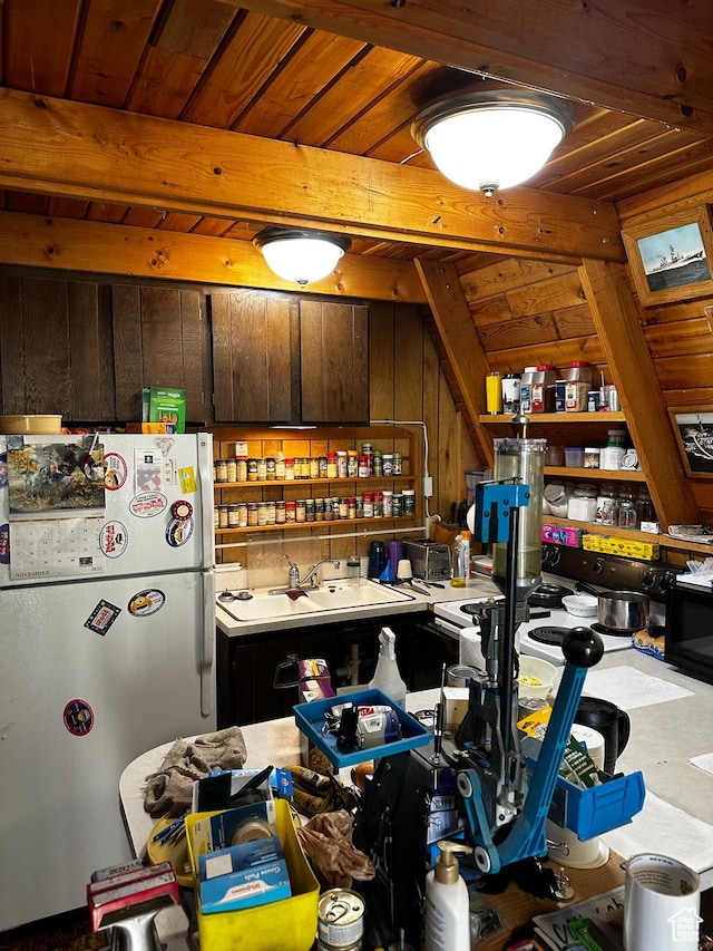 297 E Solomons Way, Manila, UT 84046 - kitchen with light countertops, freestanding refrigerator, a sink, wood walls, and beamed ceiling