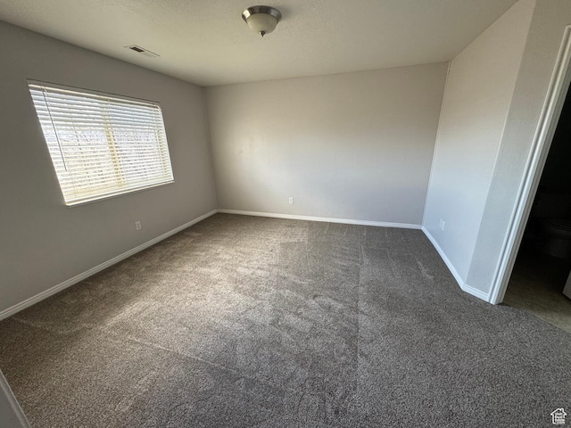 spare room with carpet and baseboards
