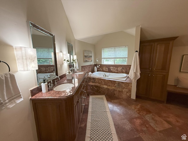 full bath featuring a garden tub, double vanity, a sink, and vaulted ceiling