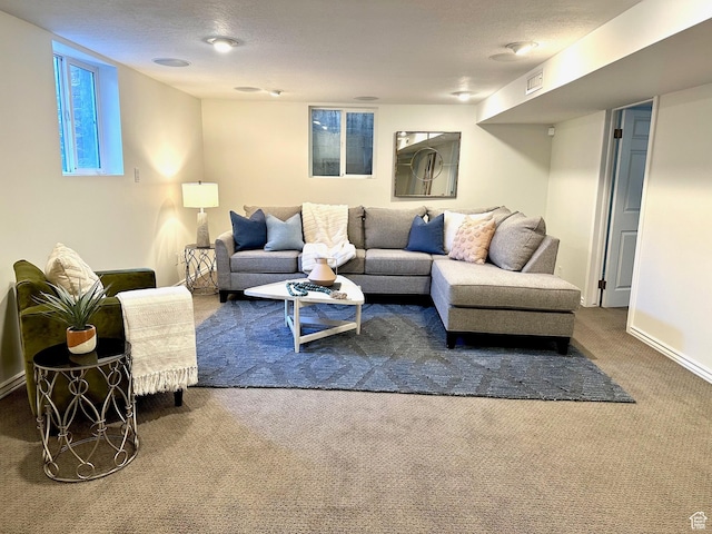 living area featuring a textured ceiling, carpet floors, and visible vents