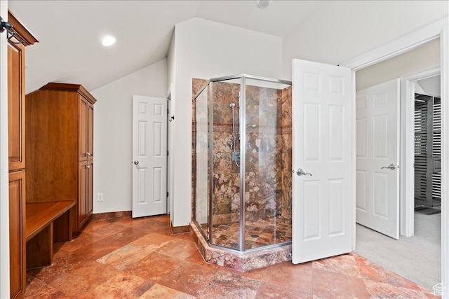 bathroom with a stall shower, stone finish flooring, baseboards, lofted ceiling, and recessed lighting