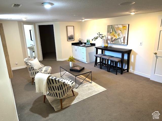 living room with dark colored carpet, baseboards, and visible vents