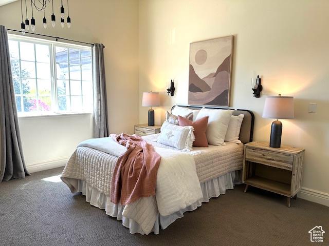 carpeted bedroom featuring baseboards