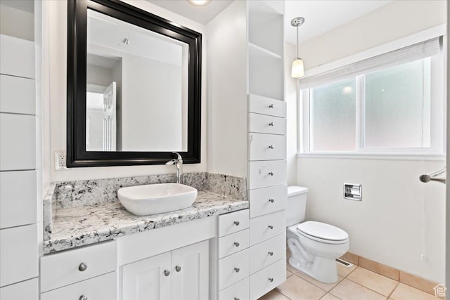 bathroom with toilet, tile patterned flooring, and vanity