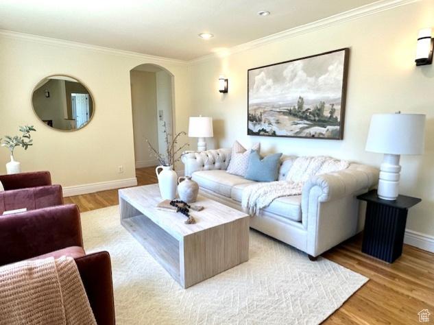 2765 E Blue Spruce Dr, Holladay, UT 84117 - living room with arched walkways, light wood-style floors, baseboards, ornamental molding, and recessed lighting
