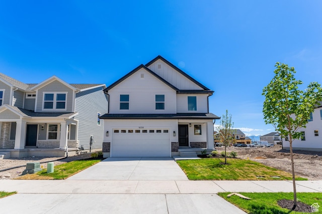 1038 N 3685 W Unit 259, Lehi, UT 84043 - view of front of house with stone siding, a porch, concrete driveway, an attached garage, and board and batten siding