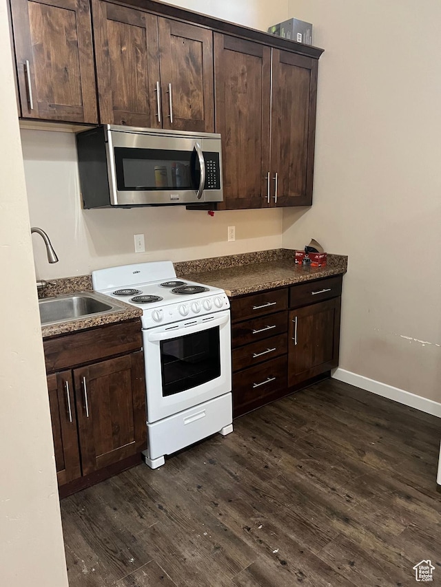 2573 S 2800 W, Roosevelt, UT 84066 - kitchen with electric stove, dark countertops, stainless steel microwave, dark wood-style flooring, and a sink