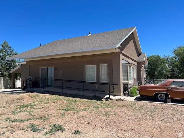 2573 S 2800 W, Roosevelt, UT 84066 - view of side of home featuring a shingled roof and stucco siding