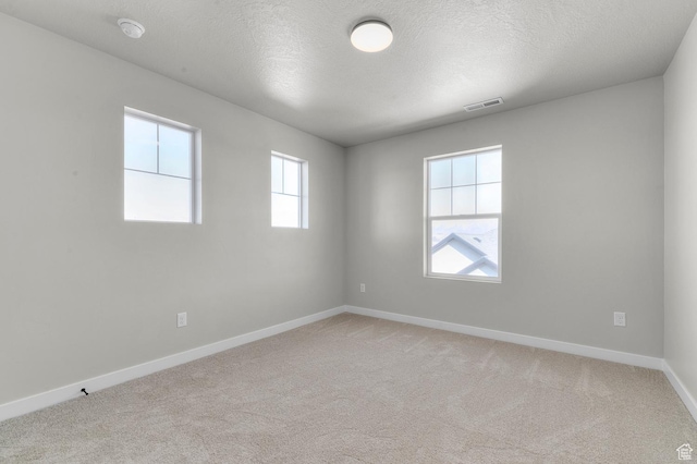 3707 W 2600 N, Lehi, UT 84043 - spare room featuring a textured ceiling, light colored carpet, visible vents, and baseboards