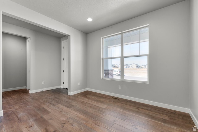 3707 W 2600 N, Lehi, UT 84043 - spare room with visible vents, baseboards, a textured ceiling, and hardwood / wood-style flooring
