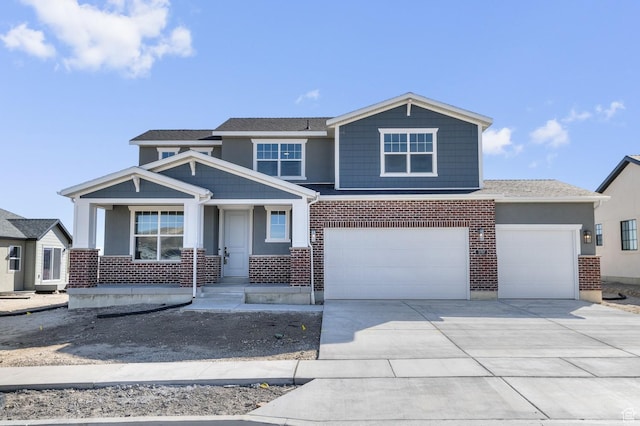 view of front facade with brick siding, concrete driveway, and an attached garage