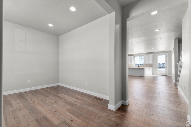 3707 W 2600 N, Lehi, UT 84043 - spare room featuring visible vents, baseboards, recessed lighting, hardwood / wood-style flooring, and a sink