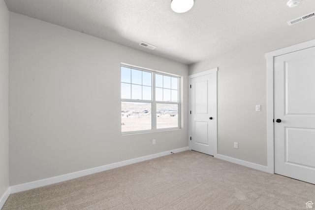 3707 W 2600 N, Lehi, UT 84043 - unfurnished bedroom featuring visible vents, light colored carpet, a textured ceiling, and baseboards