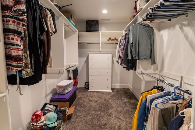 walk in closet with visible vents and dark carpet