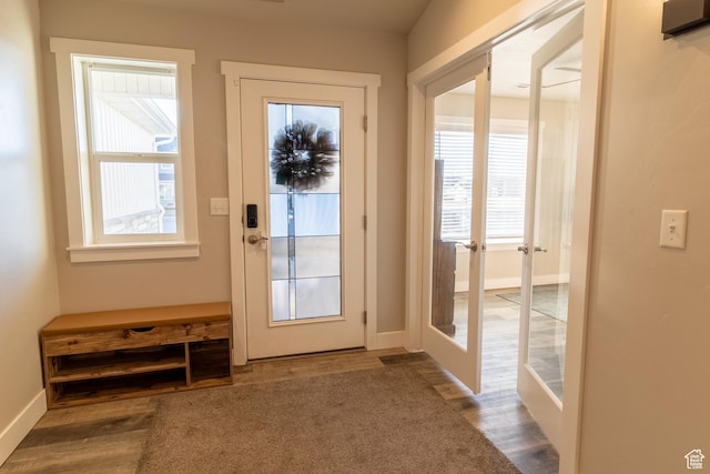 doorway with baseboards, wood finished floors, and french doors