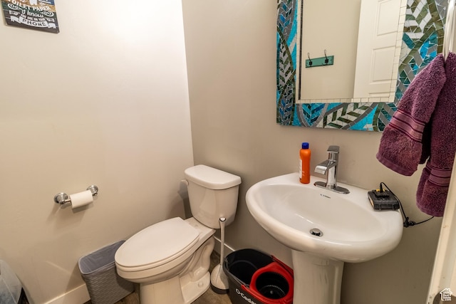 half bathroom featuring a sink and toilet