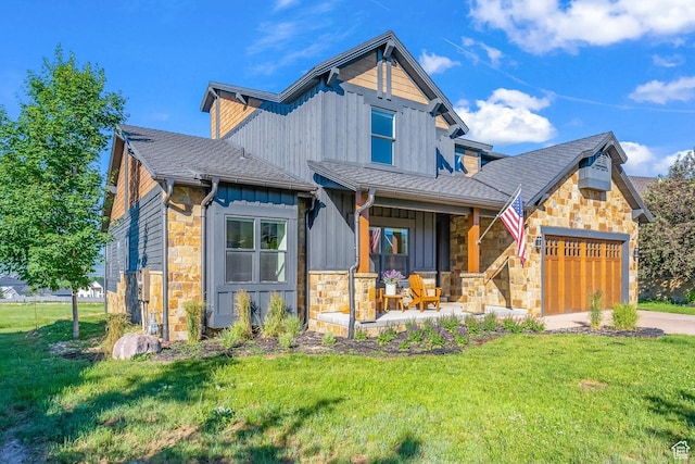 615 N Haystack Mountain Dr, Heber City, UT 84032 - view of front of house featuring a porch, an attached garage, board and batten siding, a front yard, and stone siding