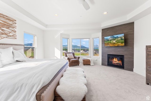 615 N Haystack Mountain Dr, Heber City, UT 84032 - bedroom with a large fireplace, a raised ceiling, a ceiling fan, carpet, and recessed lighting