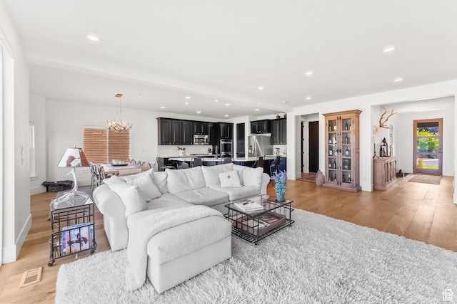615 N Haystack Mountain Dr, Heber City, UT 84032 - living area with light wood-style flooring, recessed lighting, a notable chandelier, visible vents, and baseboards
