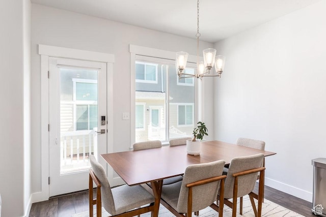 dining room with an inviting chandelier, wood finished floors, and baseboards