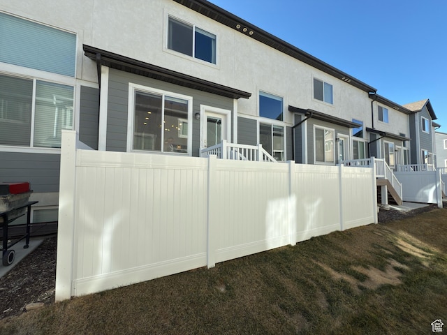 back of property featuring stucco siding