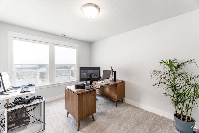home office featuring light carpet, visible vents, and baseboards