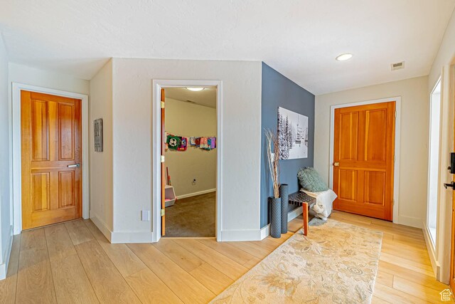 4414 Hidden Cove Rd, Park City, UT 84098 - foyer entrance with light wood-style flooring, visible vents, and baseboards