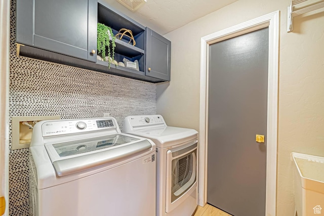 4414 Hidden Cove Rd, Park City, UT 84098 - laundry area with visible vents, washing machine and clothes dryer, and cabinet space