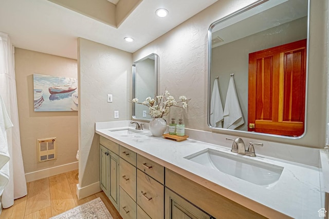 4414 Hidden Cove Rd, Park City, UT 84098 - bathroom featuring double vanity, wood finished floors, a sink, and baseboards