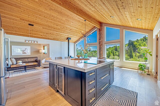 4414 Hidden Cove Rd, Park City, UT 84098 - kitchen featuring wine cooler, wood ceiling, open floor plan, light wood-type flooring, and light countertops