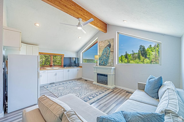 4414 Hidden Cove Rd, Park City, UT 84098 - living room with ceiling fan, light wood-style floors, recessed lighting, a glass covered fireplace, and baseboards