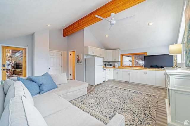 4414 Hidden Cove Rd, Park City, UT 84098 - living room featuring lofted ceiling with beams, light wood-style flooring, a ceiling fan, and recessed lighting