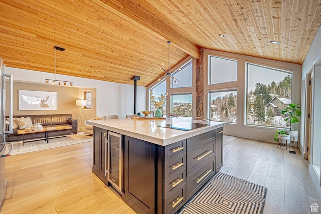 4414 Hidden Cove Rd, Park City, UT 84098 - kitchen featuring beverage cooler, wooden ceiling, decorative light fixtures, light stone countertops, and light wood-type flooring