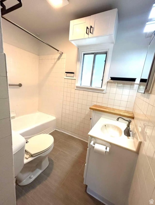 330 E 300 N, Price, UT 84501 - bathroom with tile walls, toilet, vanity, tile patterned floors, and bathing tub / shower combination