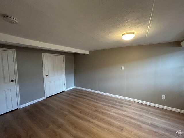 330 E 300 N, Price, UT 84501 - unfurnished bedroom featuring a textured ceiling, baseboards, and wood finished floors